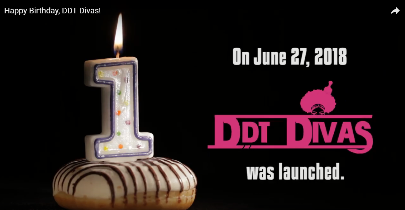 Donut with a number one birthday candle. "On June 27, 2018 DDT Divas was launched."